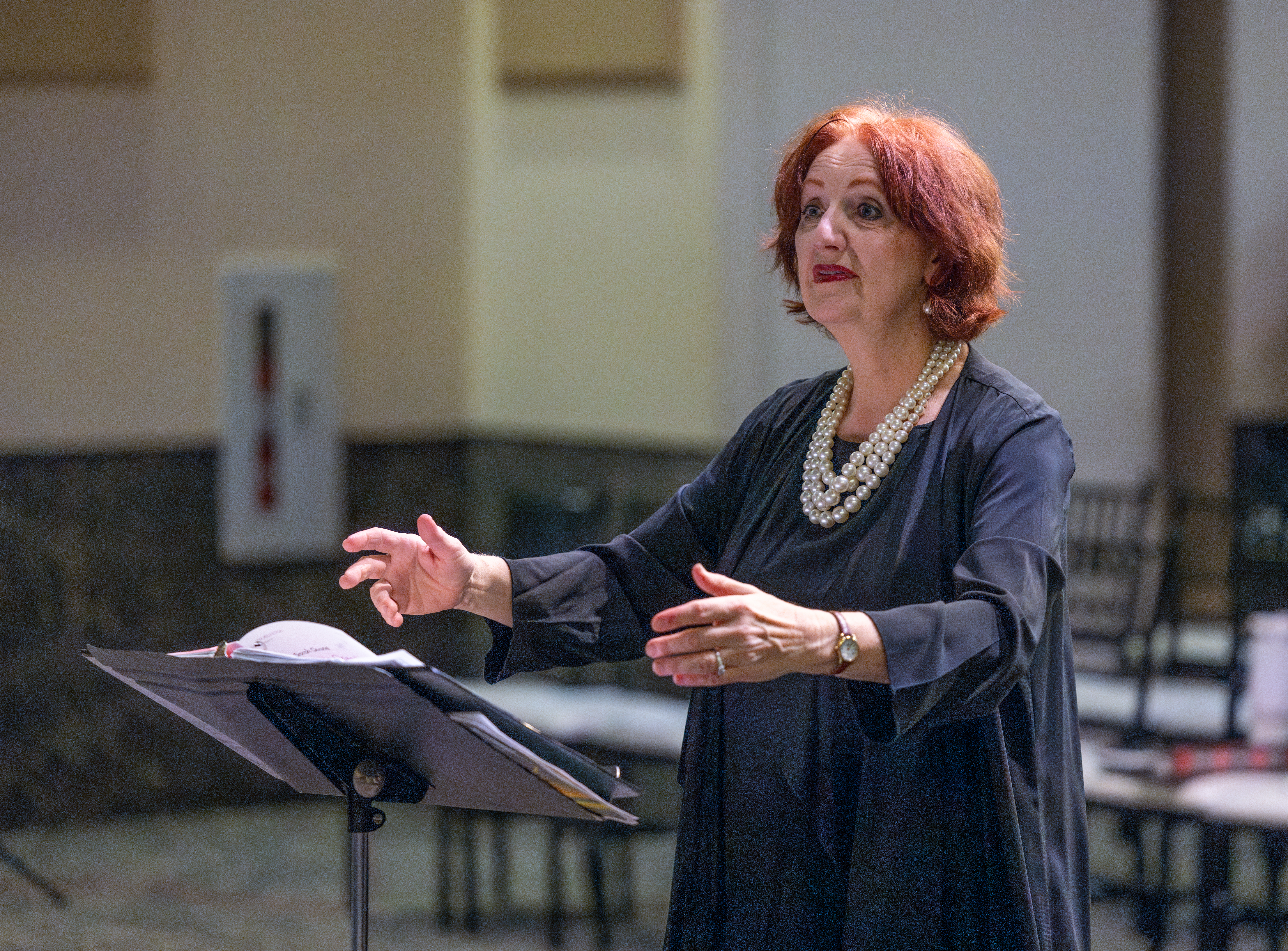 Navarro College Choir performing on stage with conductor directing
