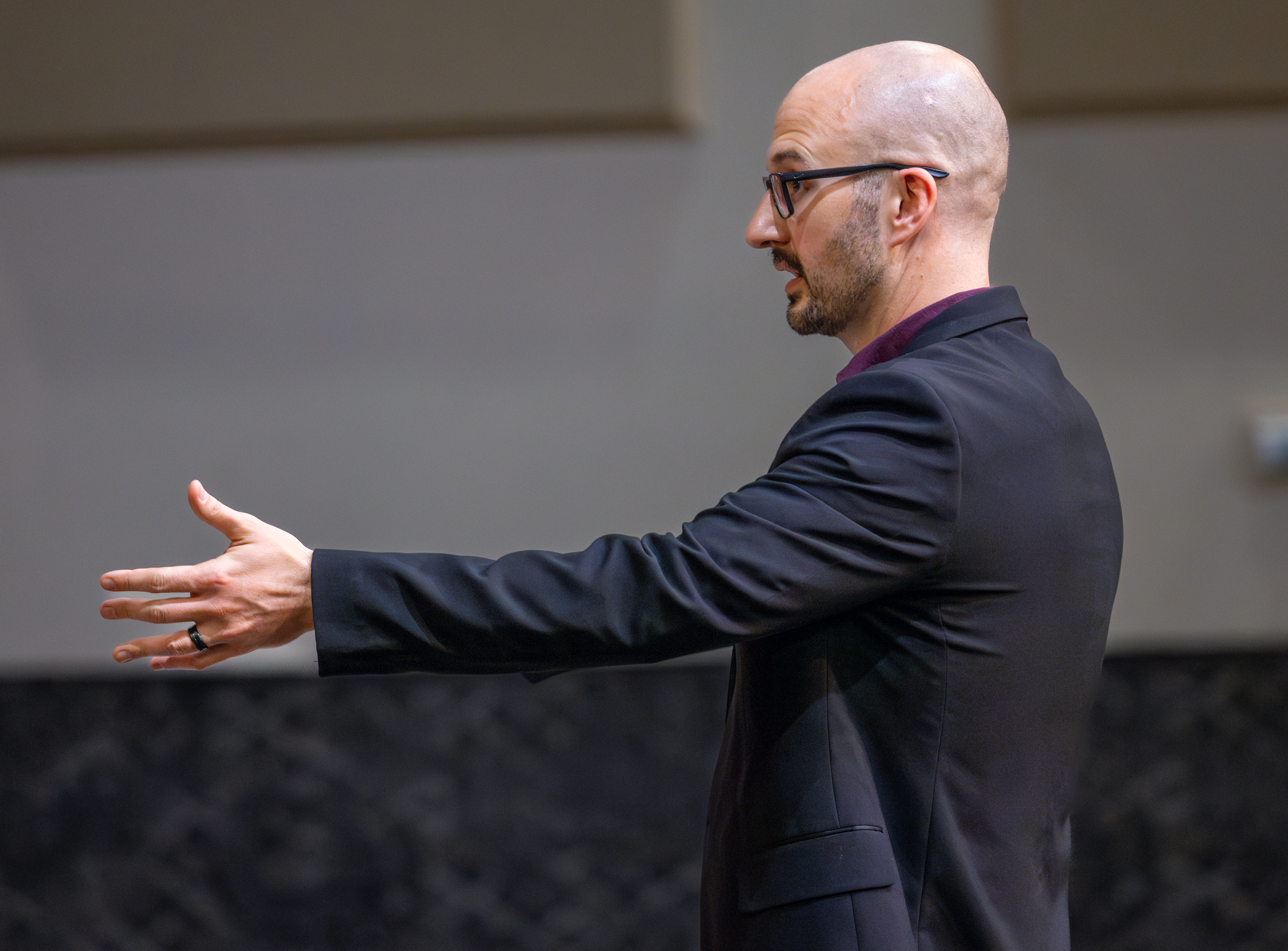 Choir conductor directing singers on stage