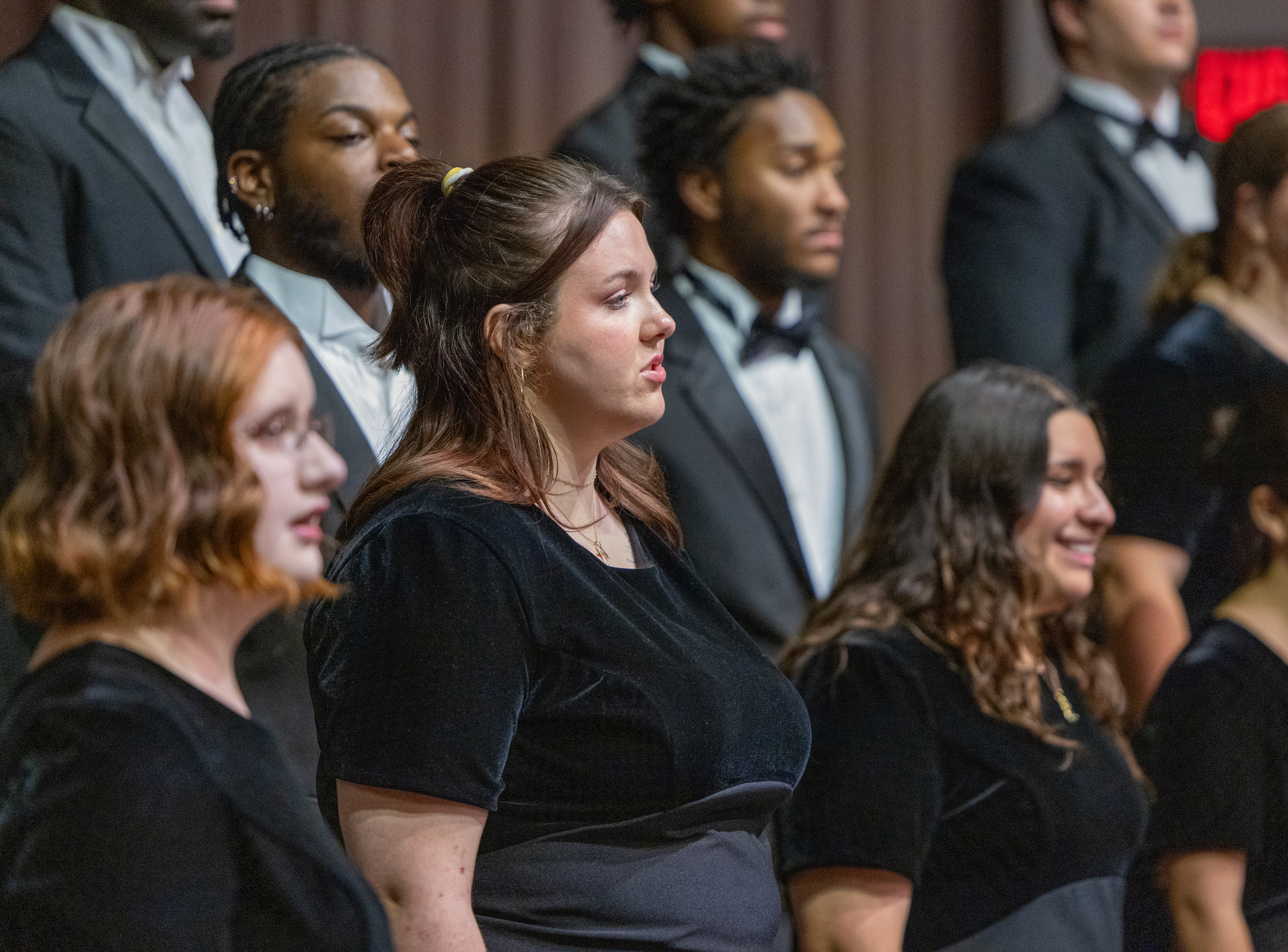 Choir members singing in formation during Fall 2024 concert