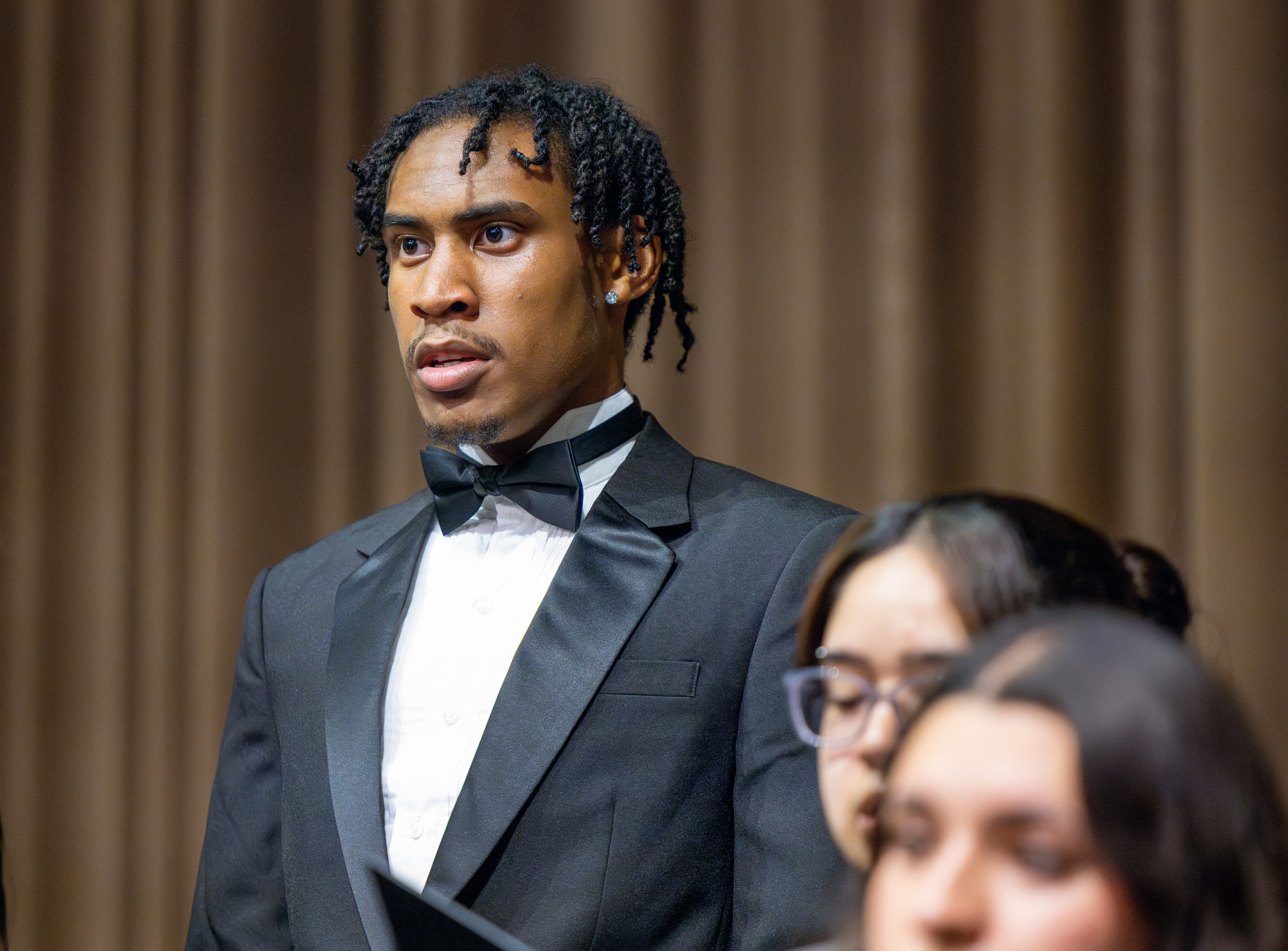 Choir in mid-performance, close-up of singer
